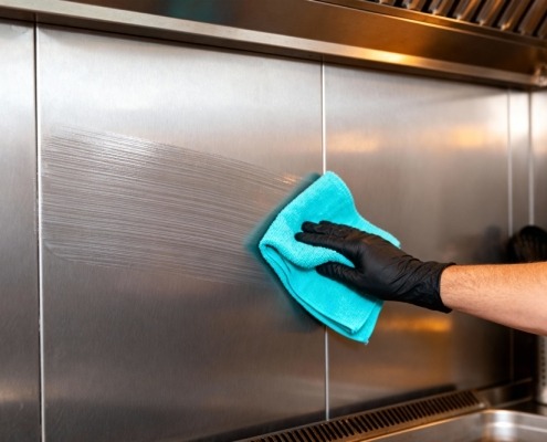 A,Gloved,Hand,Wipes,Down,A,Stainless,Steel,Surface,,Removing Αρχική